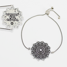 Silver mandala pendant necklace with motivational quote on a white background