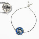 Bracelet with blue circular charm and 'I am Enough' pendant on a white background