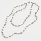 Long beaded necklace on a white background