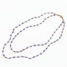Necklace with blue and gold beads on a white background