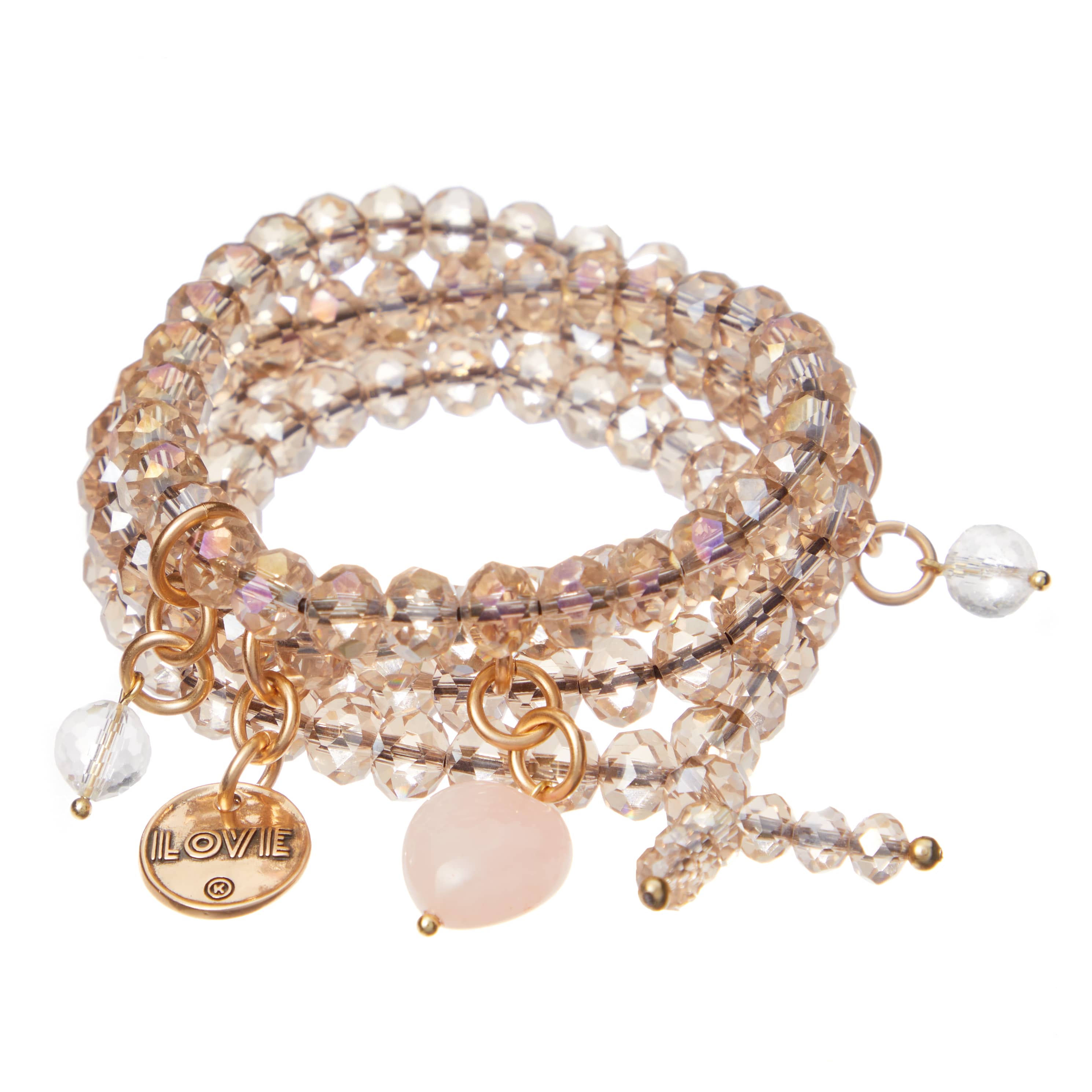 A gold finish bracelet with a rose quartz heart pendant, accompanied by crystal quartz accents and beige crystal beads, displayed on a white background.