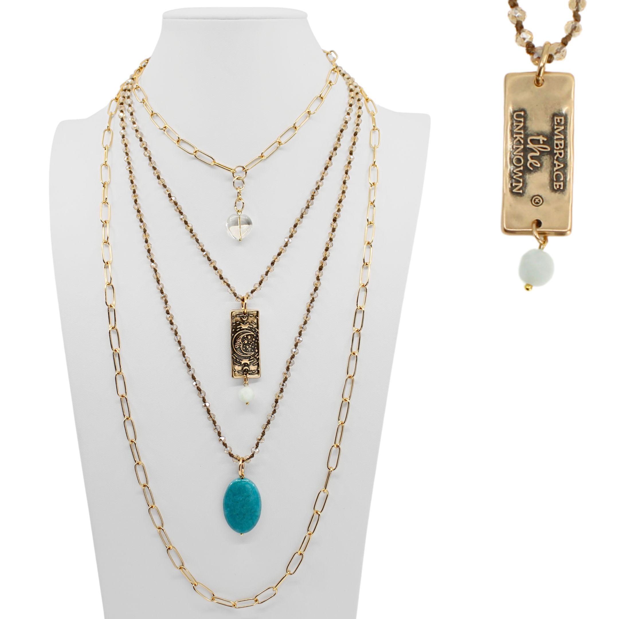 Multiple layered necklaces on a mannequin bust with a visible brand tag.