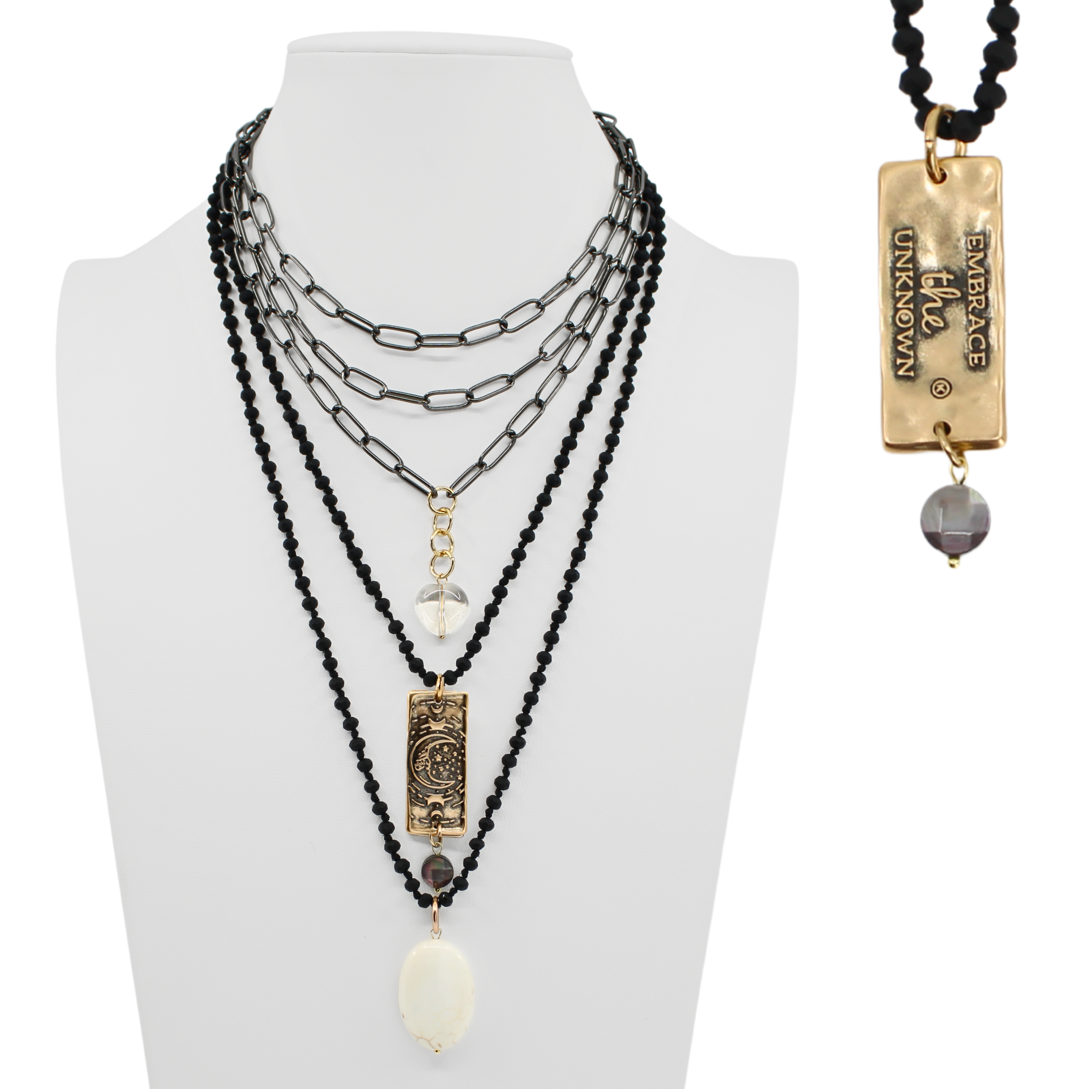 Multi-layered necklace with beads and pendants on a mannequin bust