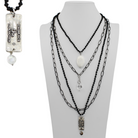 Necklace with multiple chains and pendants on a mannequin bust, with a pendant labeled 'Embrace Unknown' on the left.