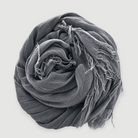 Gray scarf with tassels on a light gray background