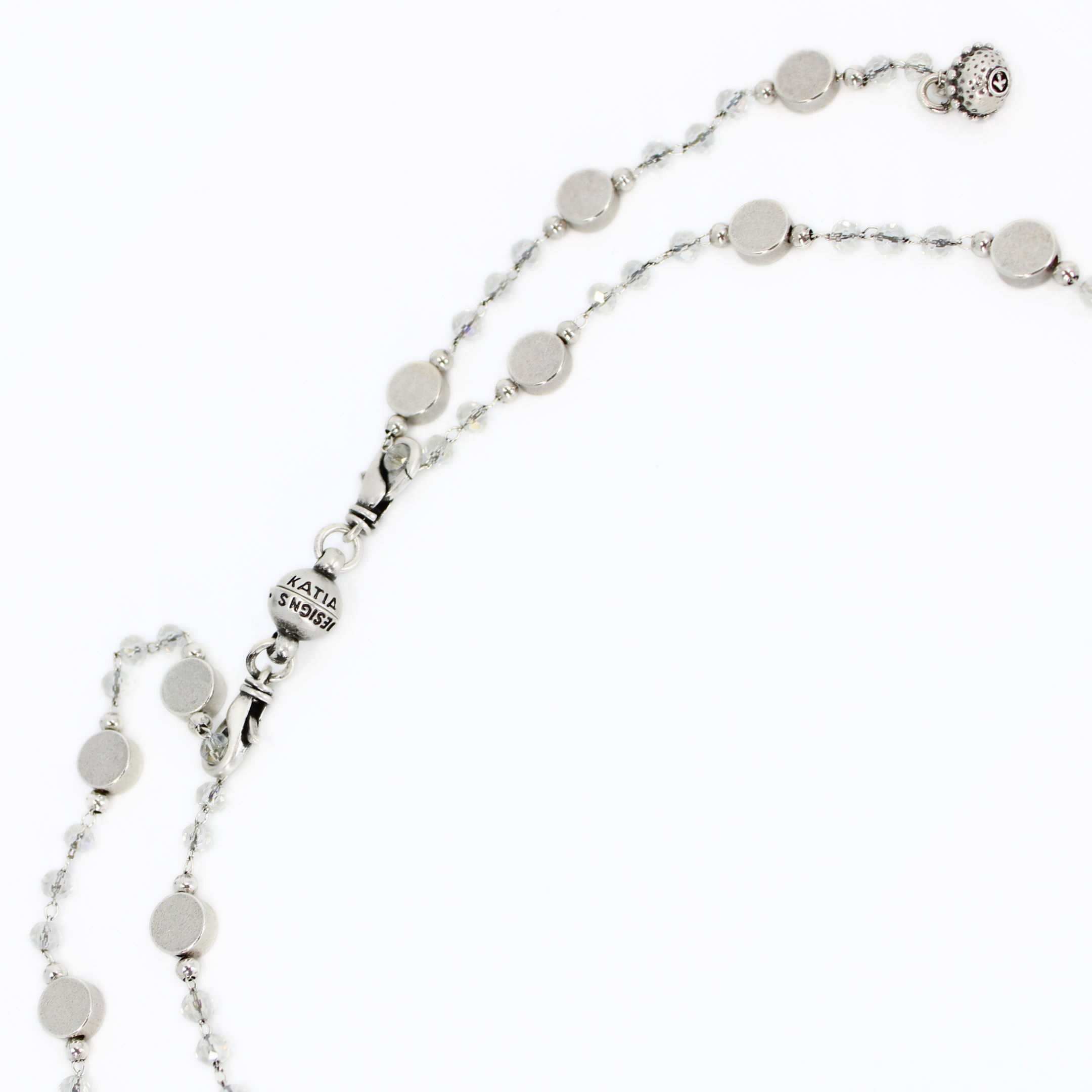 Silver necklace with round beads on a white background showing how to put on the clasp