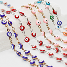 Colorful evil eye beaded necklaces on a white surface