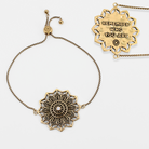 Gold mandala-style necklace with motivational pendant on a white background