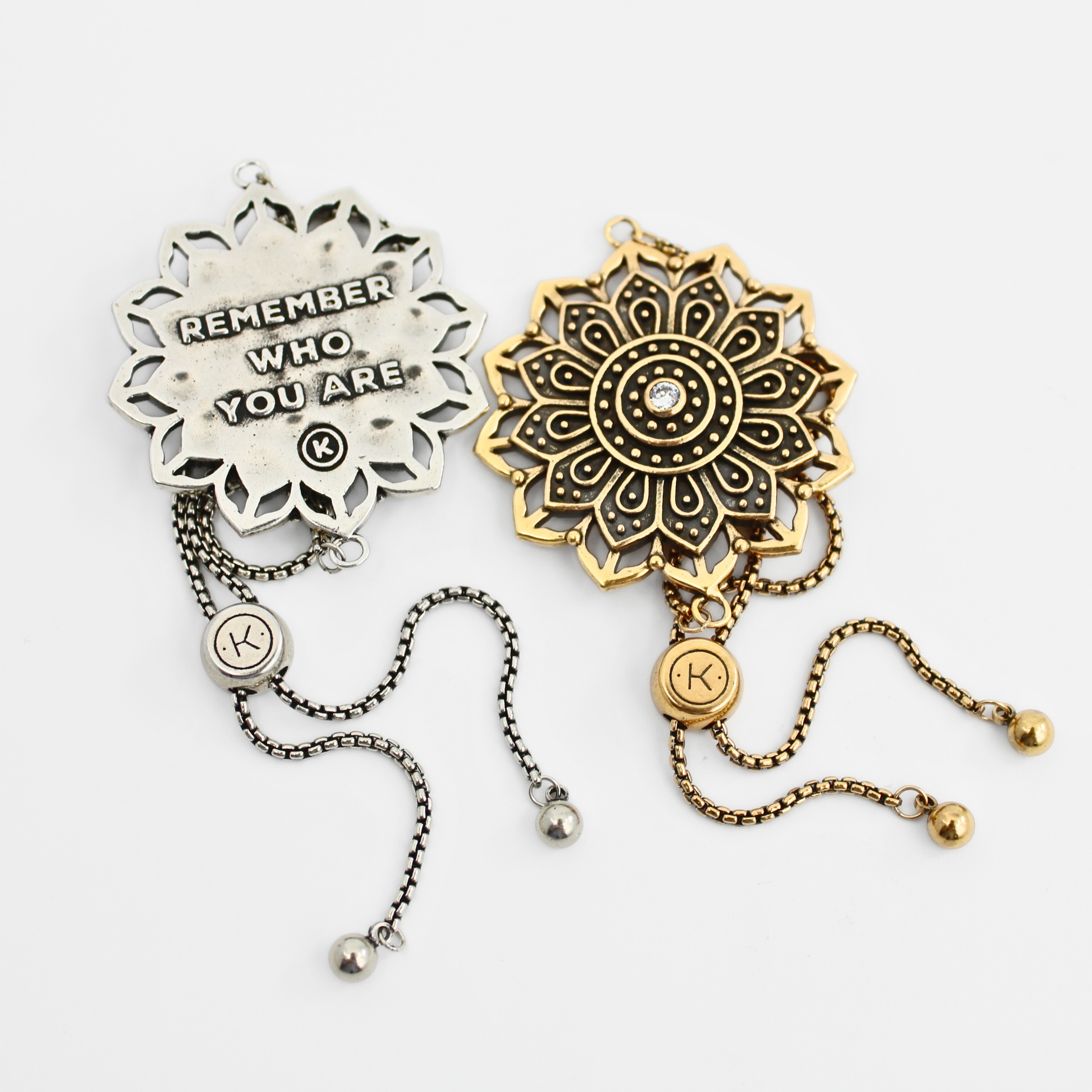 Two decorative bracelets, one silver and one gold, on a white background.