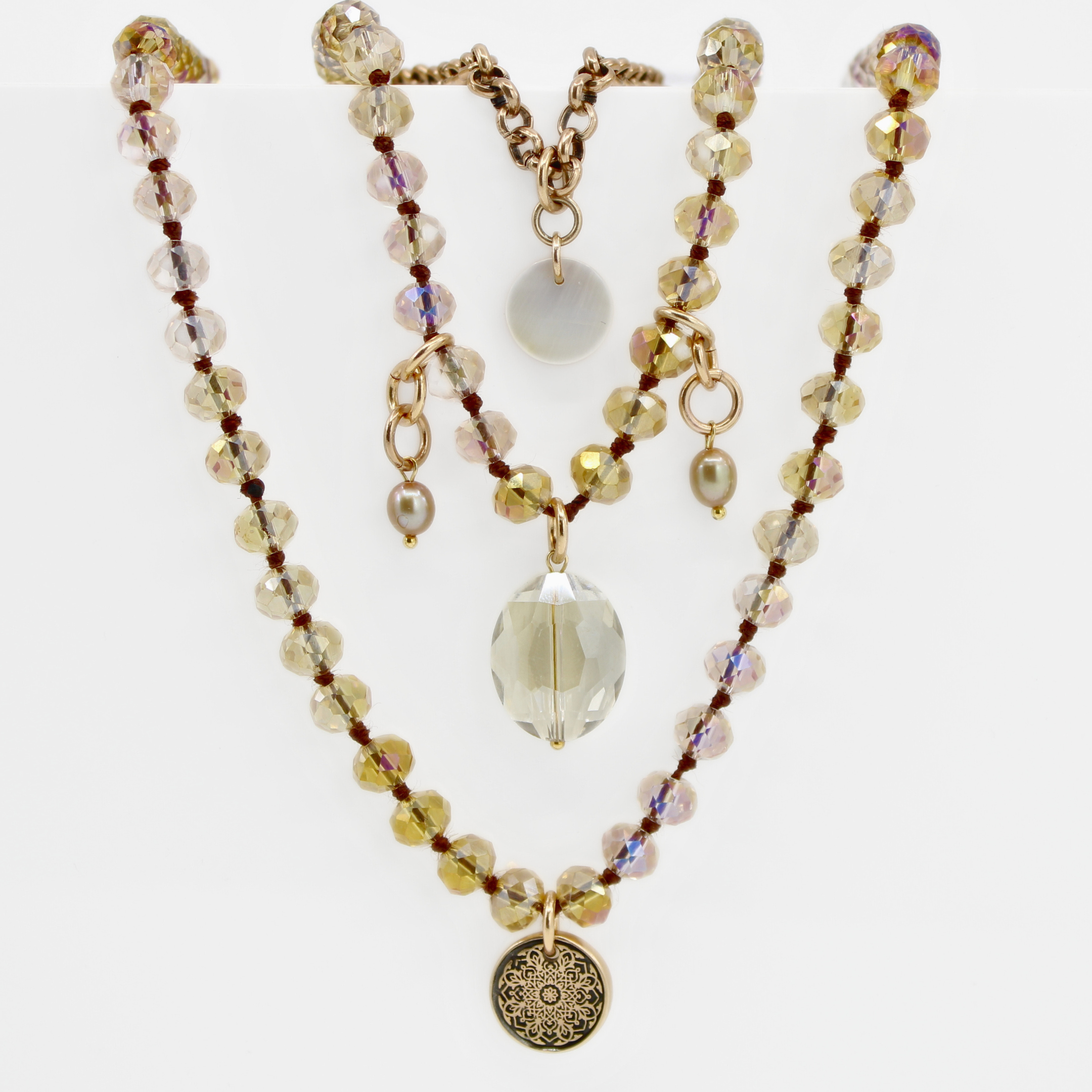 Multistrand beaded necklace with decorative elements on a white background