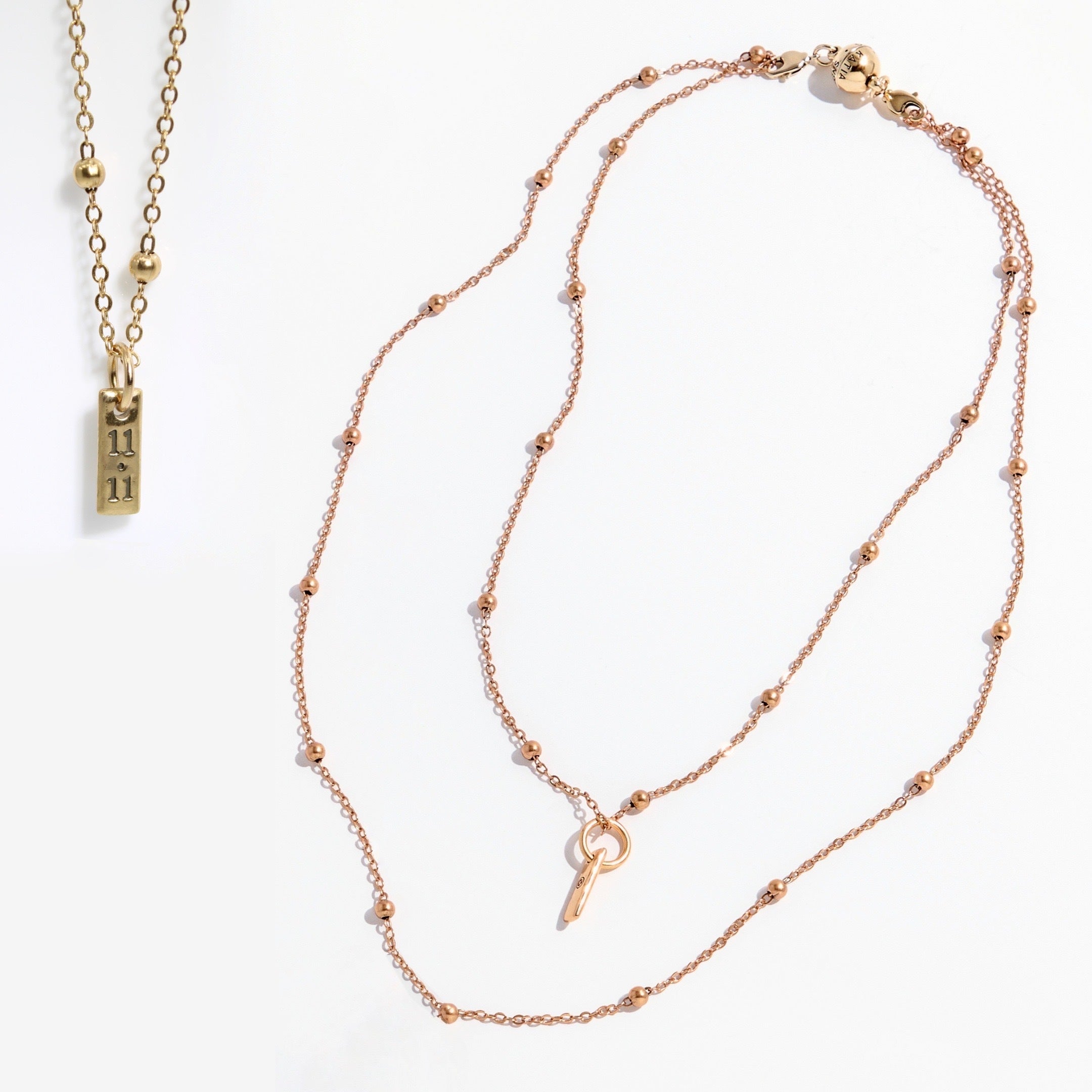 Two gold necklaces on a white background