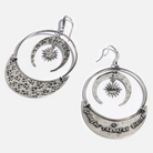 A pair of drop earrings with a hammered texture and a message inscribed on one side, available in two colors: one with an antique gold finish and the other with an antique silver finish, both featuring a star and moon design.