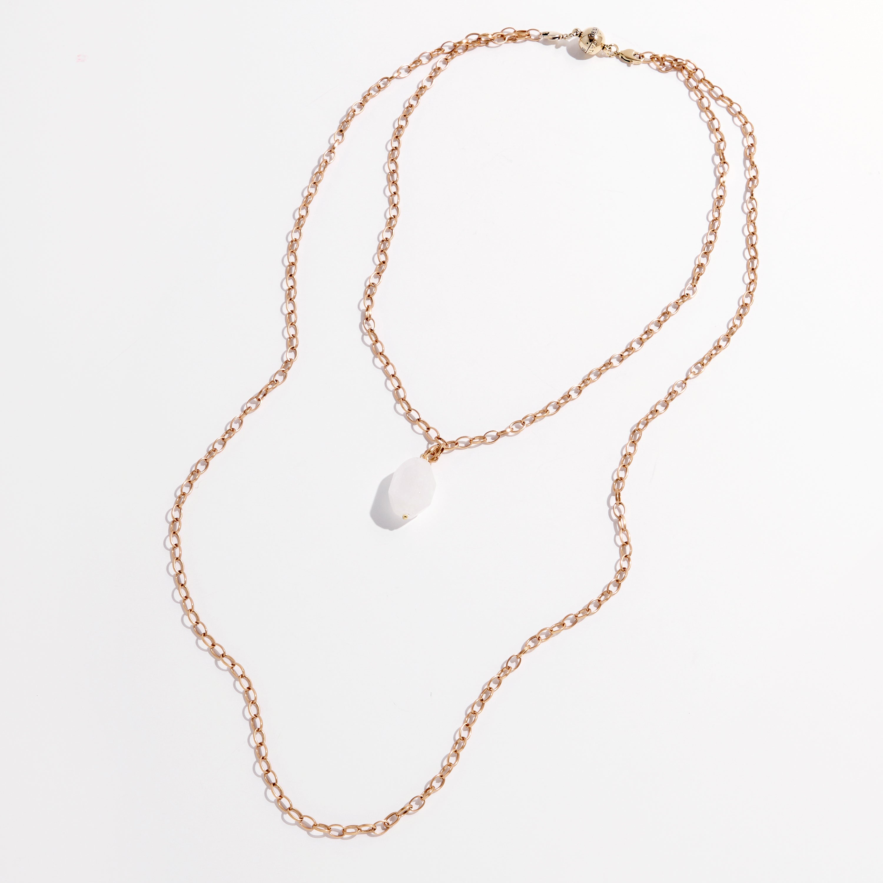 Handmade jewelry at its finest, this gold chain necklace features a white stone pendant elegantly displayed against a white background.