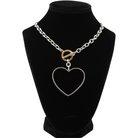 love always open heart mix metal statement choker necklace from katia designs. statement choker necklace adorned with a large hollow heart pendant, showcasing a two-tone design embellished trim and a heartfelt inscription. 
silver chain variant displayed on velvet bust.