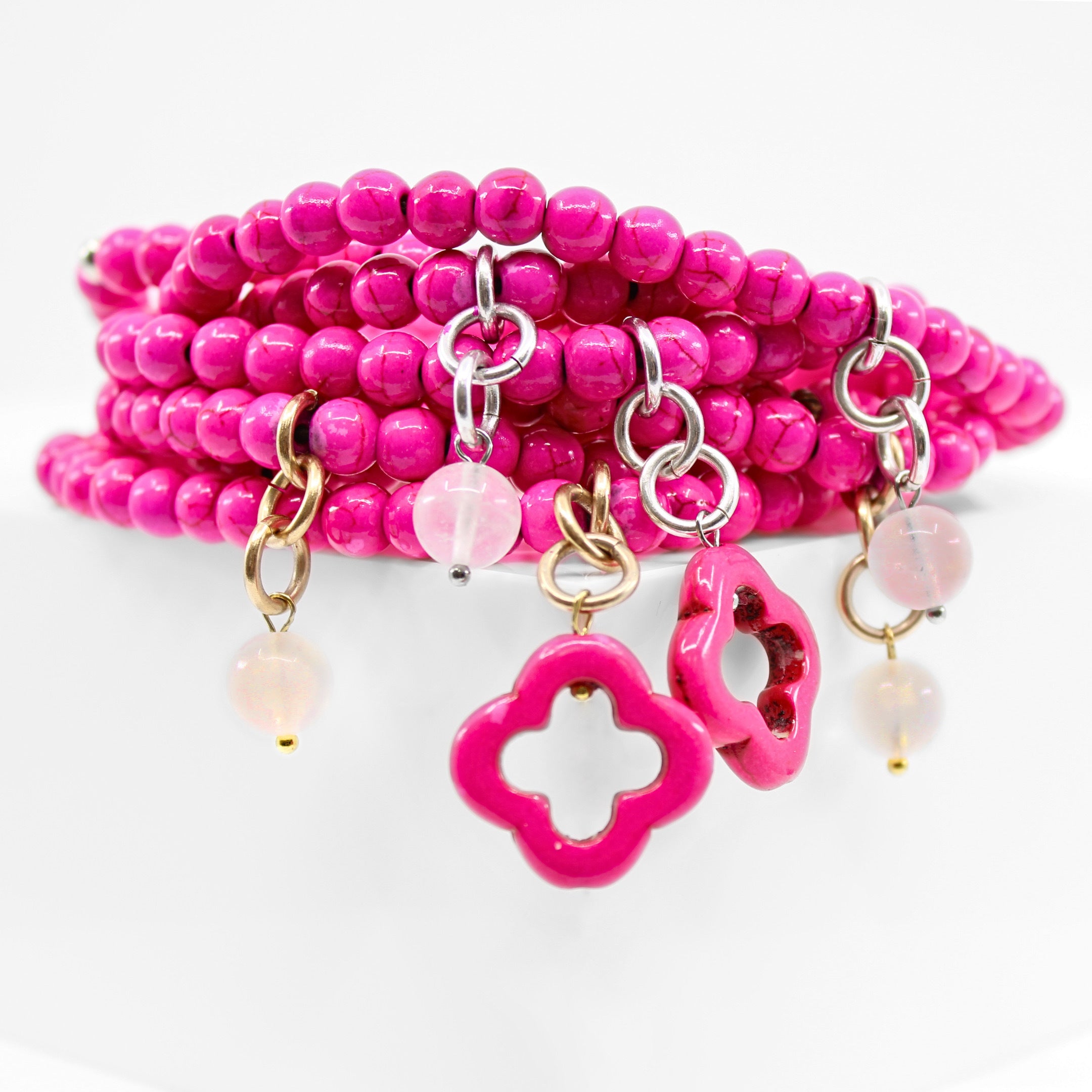 multiple colorful beaded boho wrap bracelets in 4 bright colors made with howlite beads. this image shows the pink one in both finish options