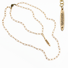 Gold chain necklace with a pendant on a white background