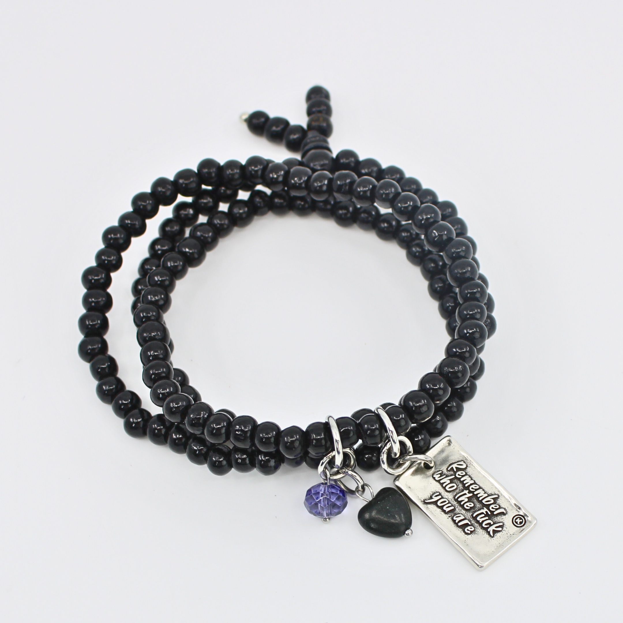 Black beaded bracelet with charms on a white background