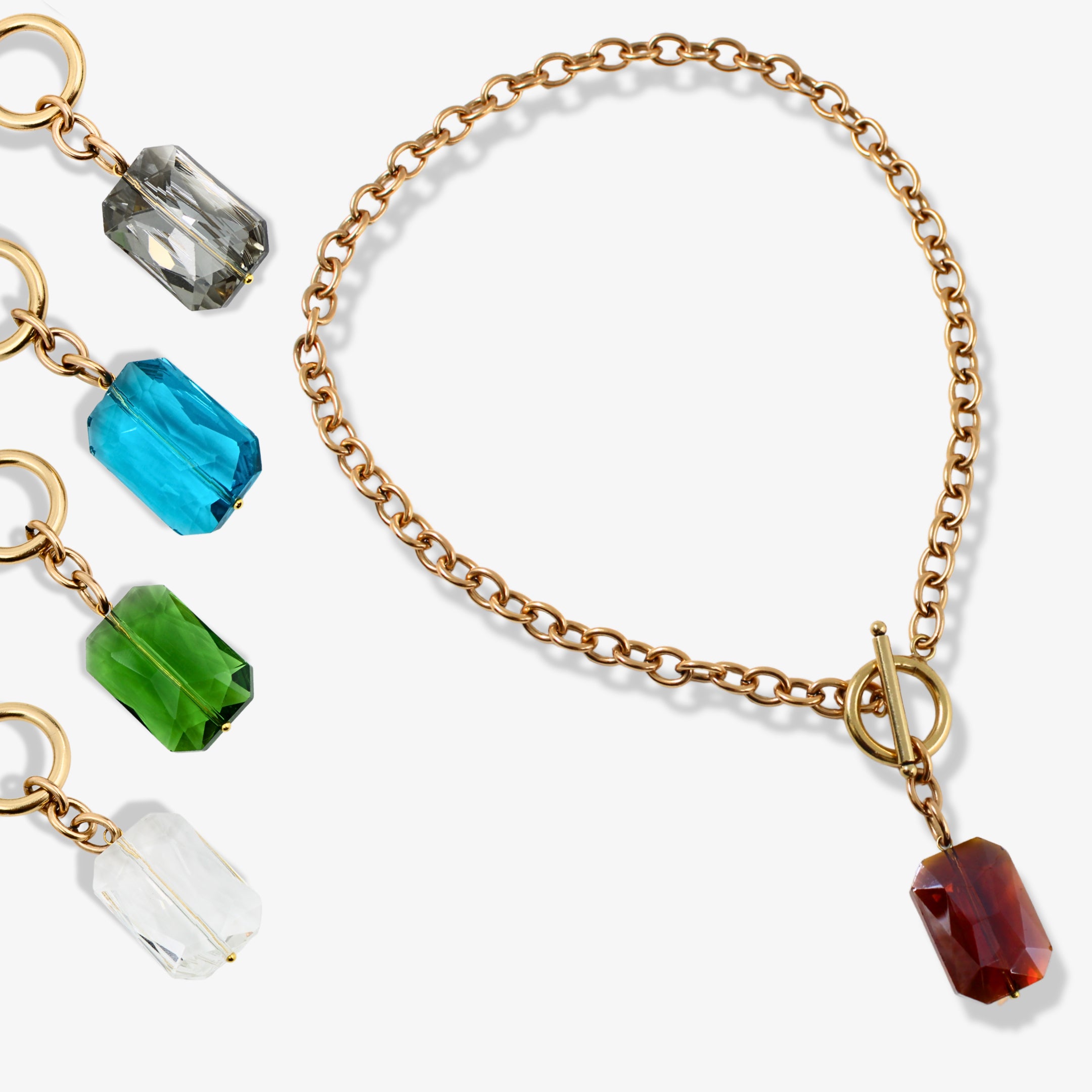 Gold chain bracelet with colorful beads on a white background