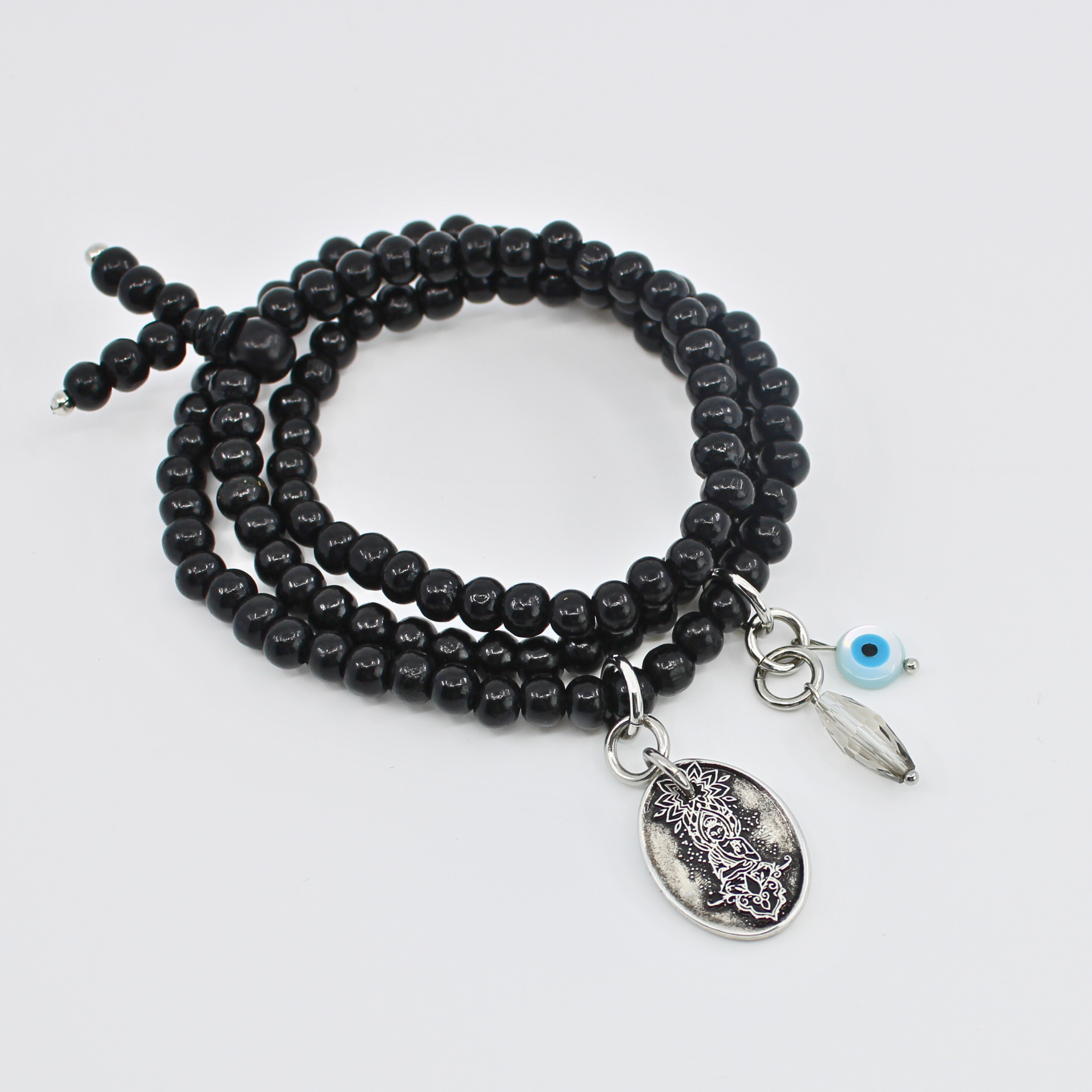 Black beaded bracelet with silver charms on a white background