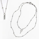 Two silver necklaces on a white background