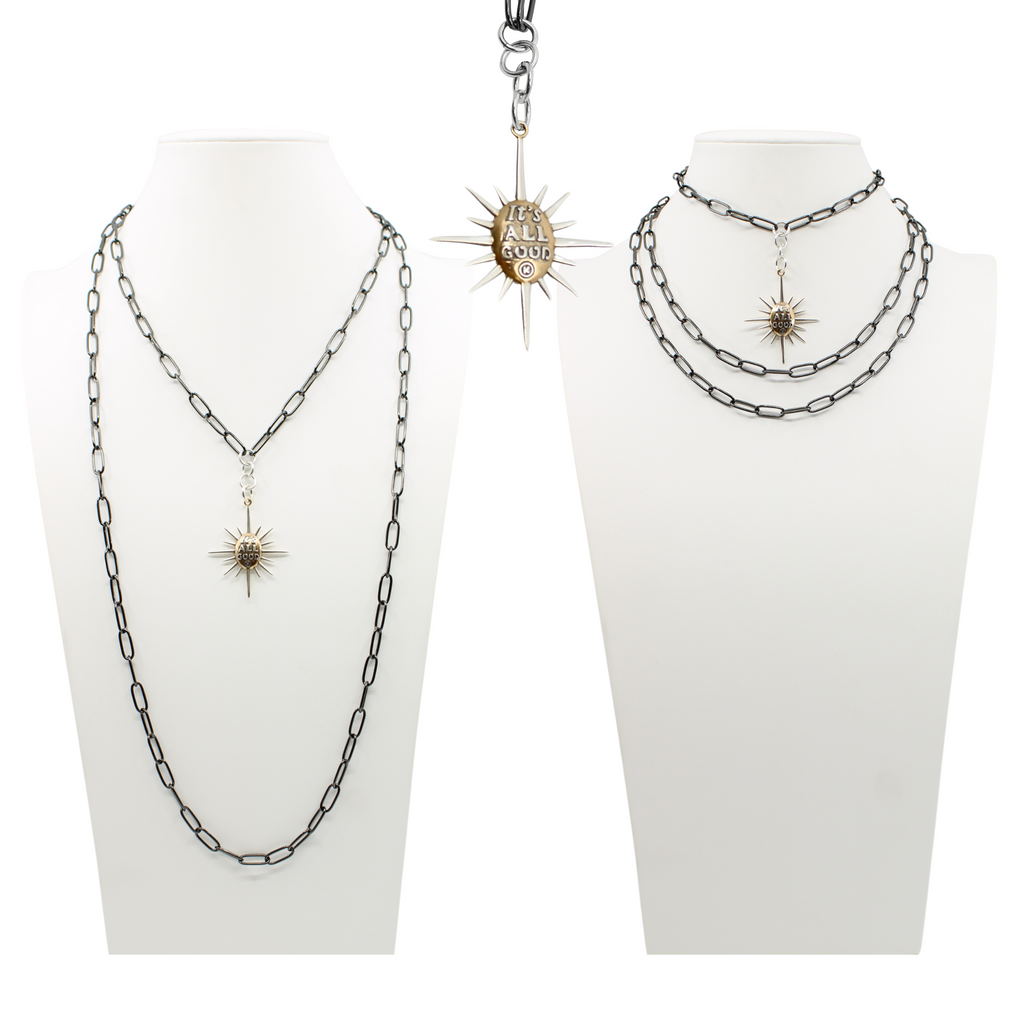 sunburst pendants on chains; one says Its all good and features a mix of silver and gold tones. both on a sleek gunmetal chain, offering a modern twist with its subtle magnetic clasp for easy wear.