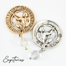 Two necklaces with gold and silver chains, featuring circular pendants with zodiac signs, and faceted crystal quartz accents.