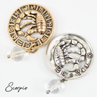 Two necklaces with gold and silver chains, featuring circular pendants with zodiac signs, and faceted crystal quartz accents.