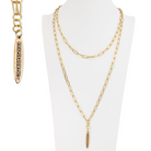Gold chain necklace and bracelet on a white mannequin bust