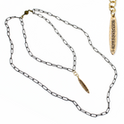 Gold and silver chain necklace with branded pendants on a white background