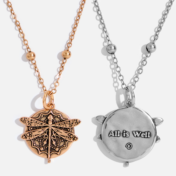dragonfly pendant detail in gold and silver with message on back reads "all is well"