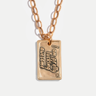 Gold necklace with a pendant that reads 'I am pretty fucking awesome' on a light background