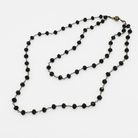Black beaded necklace on a white background