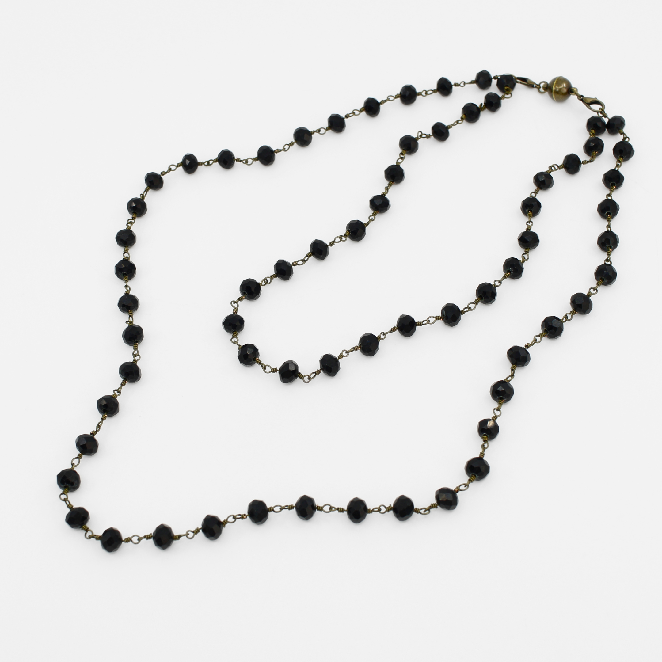 Black beaded necklace on a white background