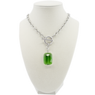 Necklace with a green pendant on a white mannequin bust