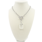 Silver necklace with a clear pendant on a mannequin bust against a white background
