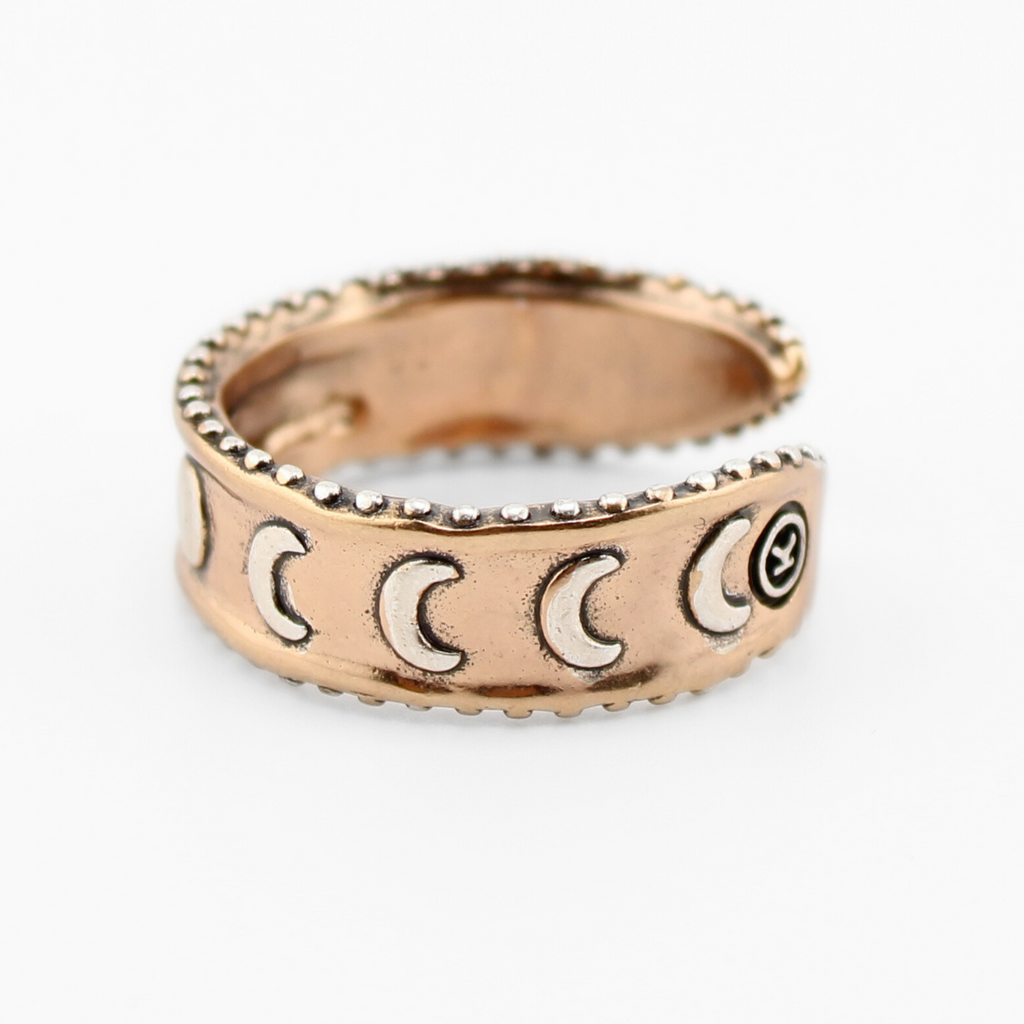 mixed-metal rings with crescent moon design and TRUST engraved inside, each featuring adjustable bands, are shown from different angles.