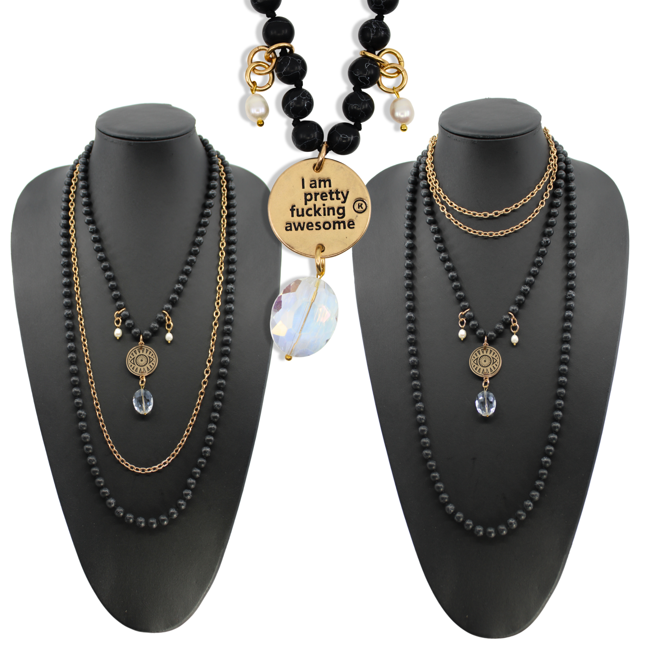 Black beaded necklaces with gold accents on black mannequin busts against a white background.