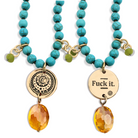 Turquoise beaded necklaces with gold and amber pendants on a white background