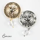 Two necklaces with gold and silver chains, featuring circular pendants with zodiac signs, and faceted crystal quartz accents.