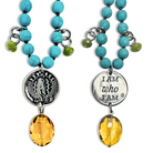 Necklace with turquoise beads, green accents, and yellow pendants on a white background