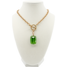 Necklace with a green pendant on a white mannequin bust