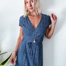 dragonfly pendant detail in gold and silver with message on back reads "all is well"