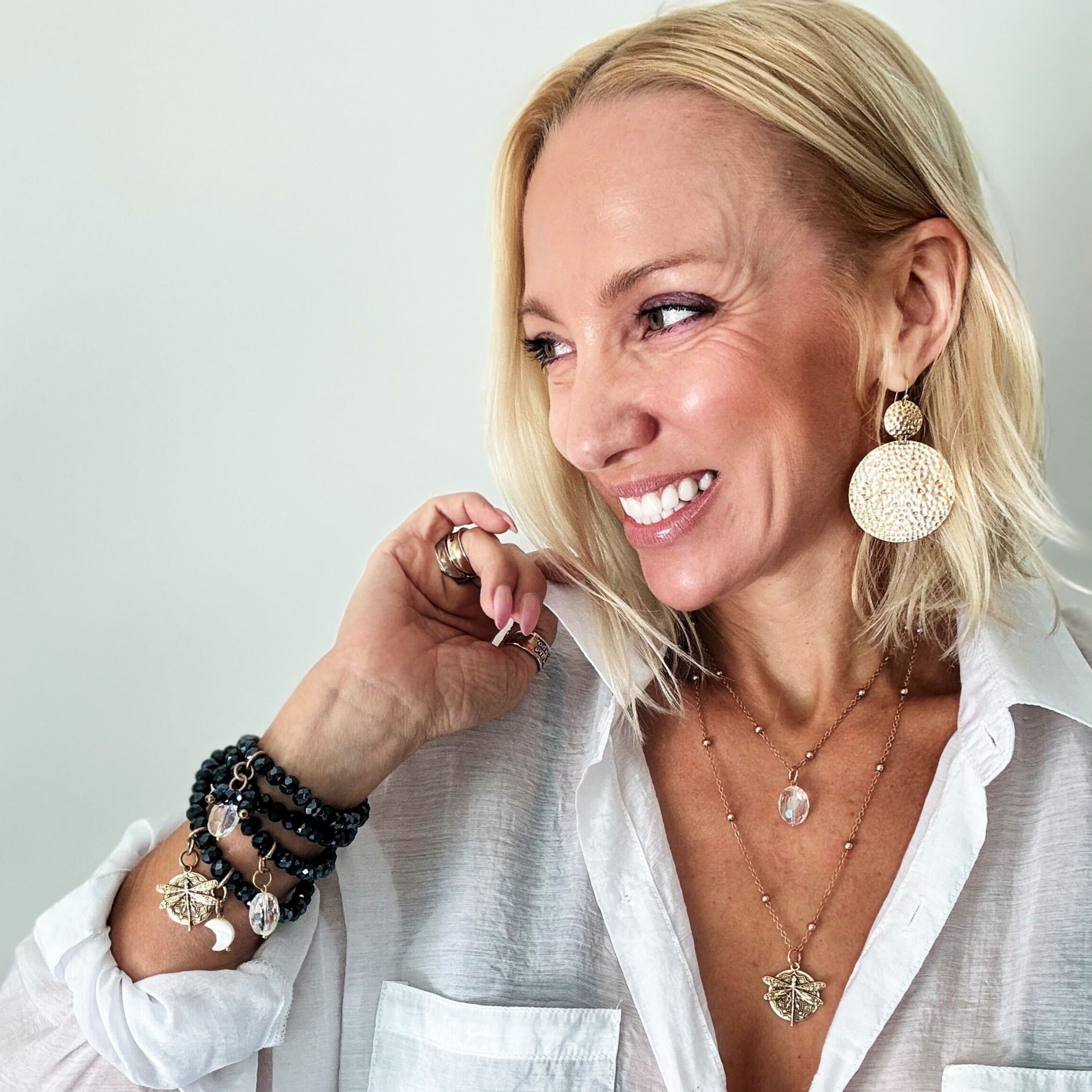 dragonfly pendant detail in gold and silver with message on back reads "all is well"