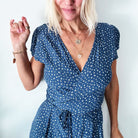 dragonfly pendant detail in gold and silver with message on back reads "all is well"