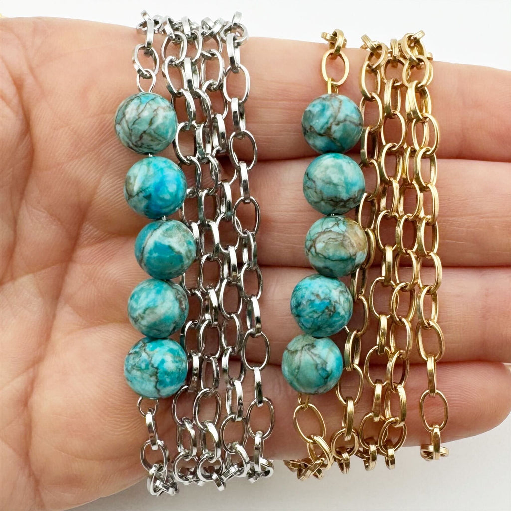 Stainless steel necklace featuring a gold and silver chain with a row of five Aqua Terra Jasper beads, beautifully marbled in blue. Perfect for layering.