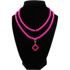 multiple colorful beaded boho wrap bracelets in 4 bright colors made with howlite beads. this image shows the pink one on a black bust worn as a necklace