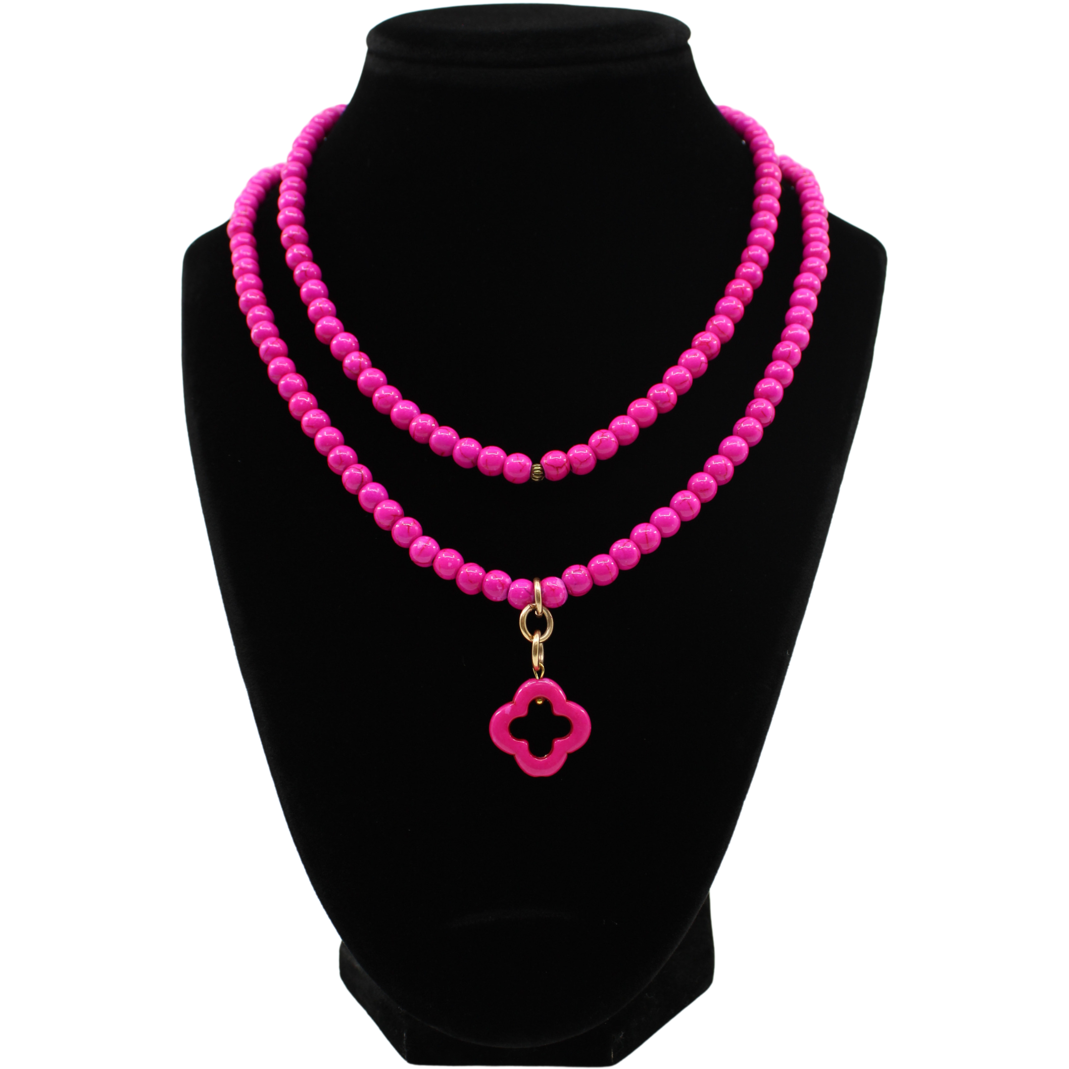 multiple colorful beaded boho wrap bracelets in 4 bright colors made with howlite beads. this image shows the pink one on a black bust worn as a necklace