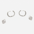 GIF of silver huggie hoops with pave heart charms