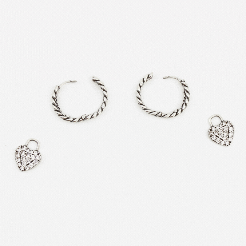 GIF of silver huggie hoops with pave heart charms