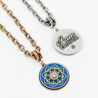 Necklace with blue and gold pendant and silver tag on a white background